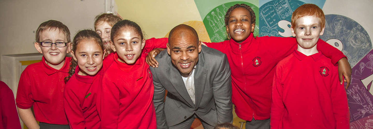 The mayor, Marvin Rees, with six school age kids of different genders and ethnicities